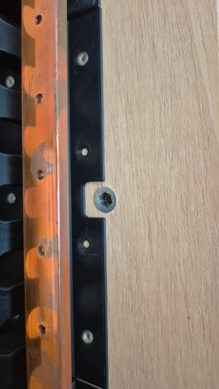 The busbar's mounting holes, drilled to match the cell terminal spacing.