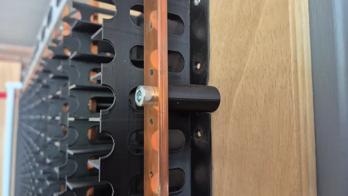A copper busbar and its 3D-printed support.
