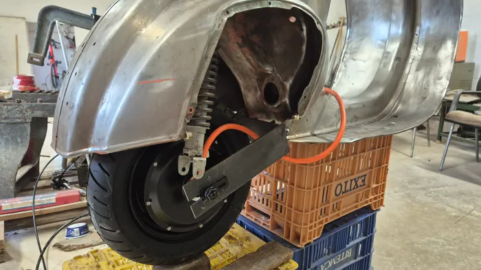 Test-fitting the motor and wheel into the primed fender.